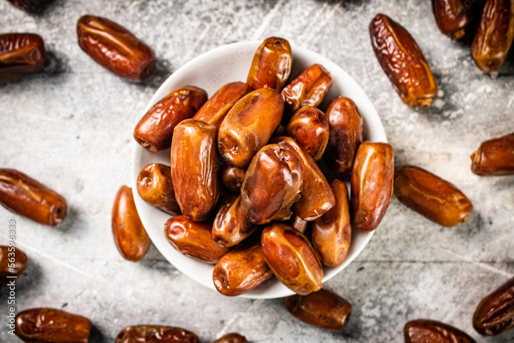 Full bowl with dates on the table. Full bowl with dates on the table.