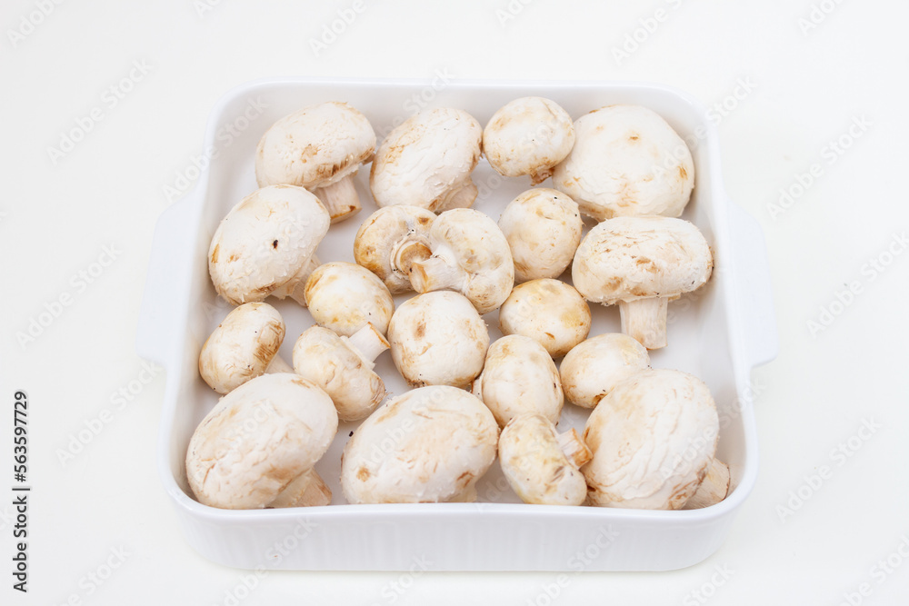 Fresh champignon mushrooms in a white plate. step-by-step recipe for cooking stuffed mushrooms. Step 2