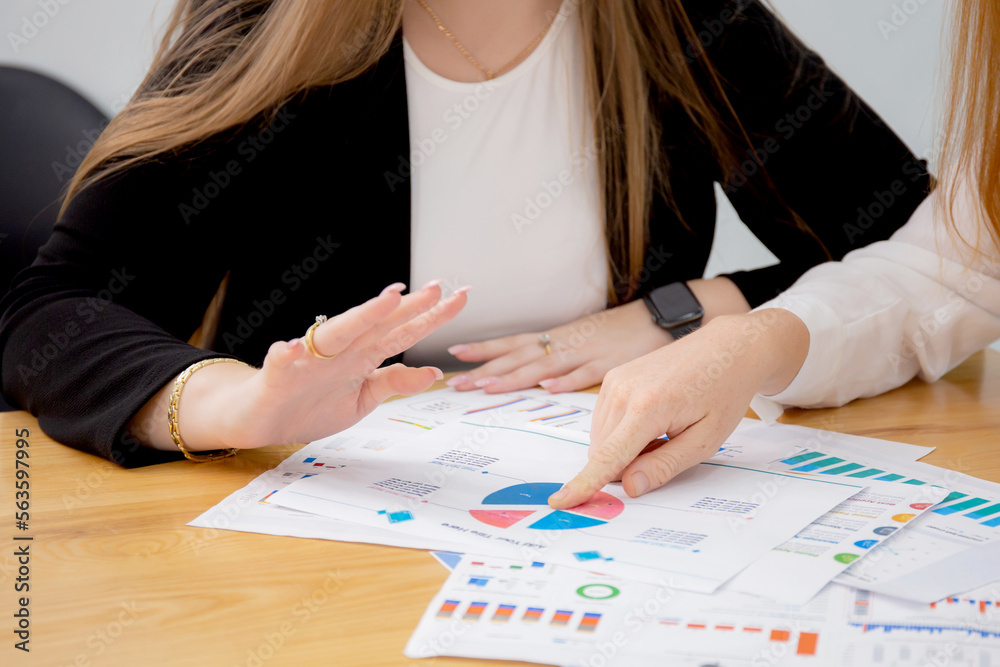 Closeup hands of group business people meeting team for planning and strategy marketing at office, manager and employee discussing conference about finance of investment with graph and chart report. Closeup hands of group business people meeting team for planning and strategy marketing at office, manager and employee discussing conference about finance of investment with graph and chart report.