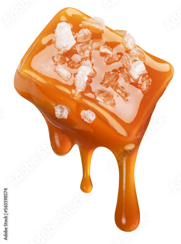Foto Salty caramel candy and drops of milk caramel sauce flowing down from it