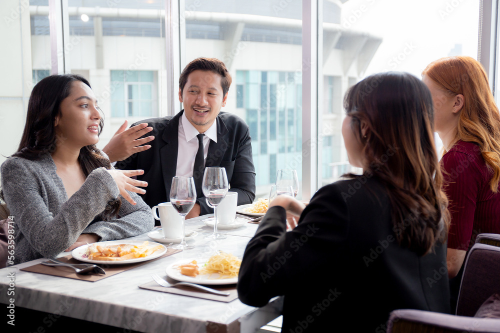 Fototapeta premium Happy team young business people in party celebrate success talking and conversation together with enjoyment at restaurant luxury, friendly and social colleague, meet friend and community concept.