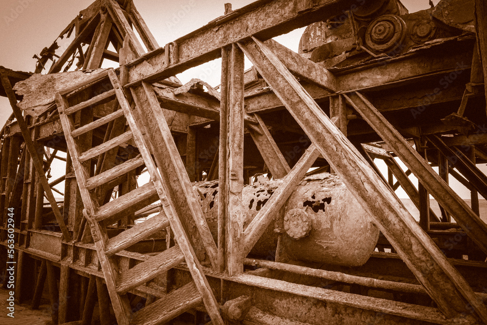 The rusted remains of an abandoned oil drilling rig between Henties Bay and Torra Bay, Skeleton Coast, Namibia.	