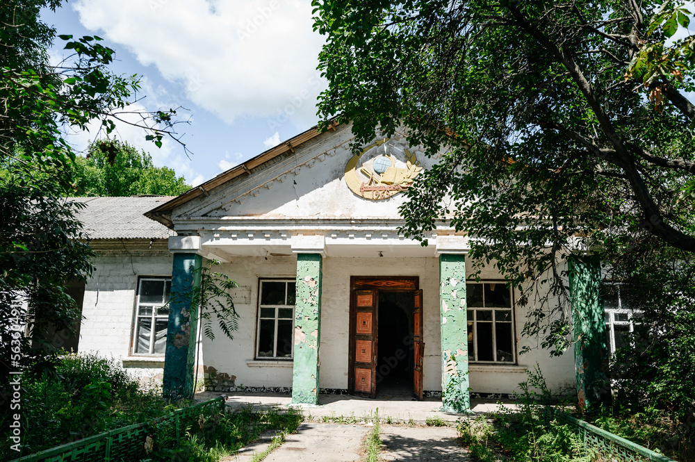 Ruins of an abandoned school in Ukraine, broken windows and doors in the school.