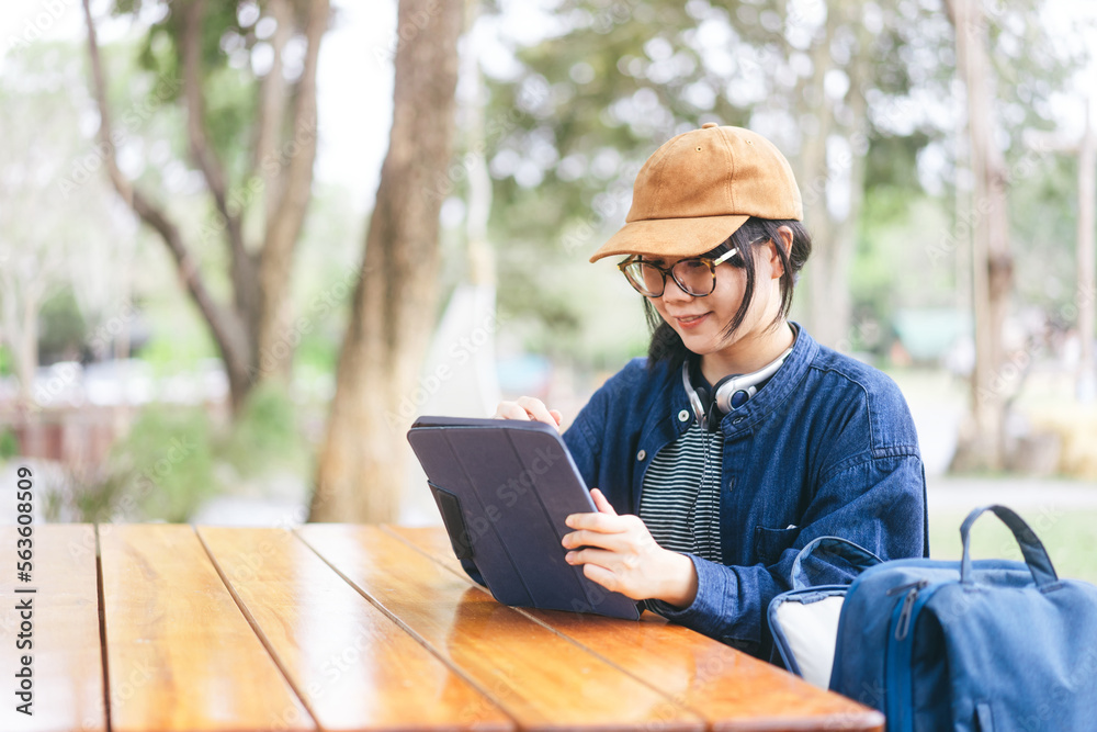 Young adult asian woman using digital tablet for digital nomad work and study Young adult asian woman using digital tablet for digital nomad work and study