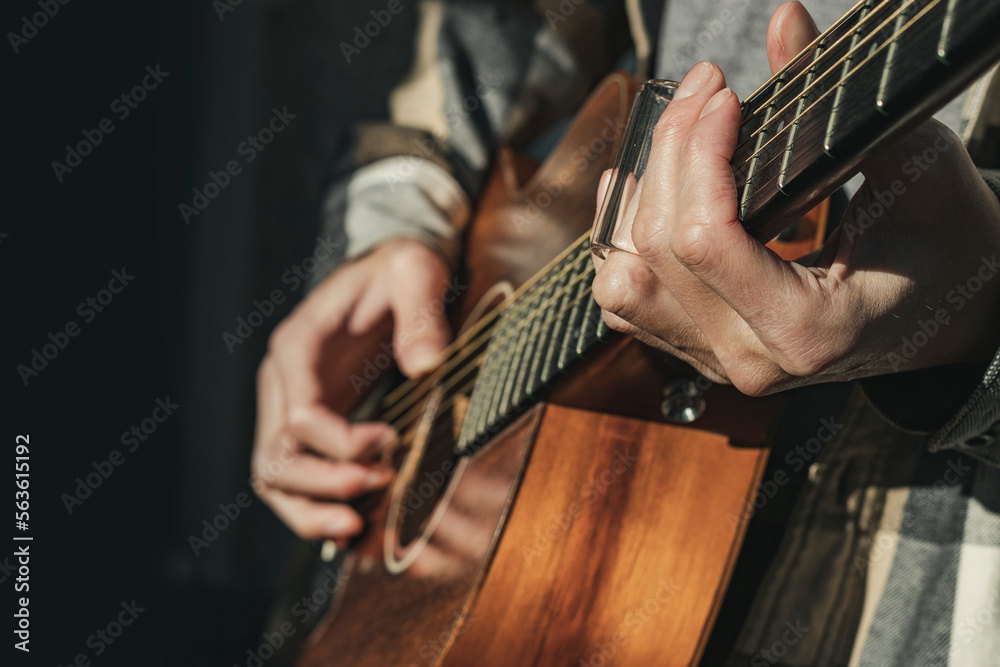 Man Playing Slide Guitar on Acoustic Outdoors - Wide Aperture Man Playing Slide Guitar on Acoustic Outdoors - Wide Aperture