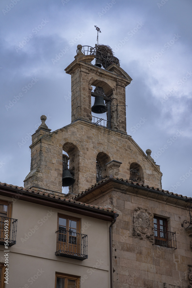 Bell tower of the Church of San Martín de Tours in Salamanca (Spain). View of an old bell tower with a stork's nest. Façade of a historic building in the monumental city of Salamanca.