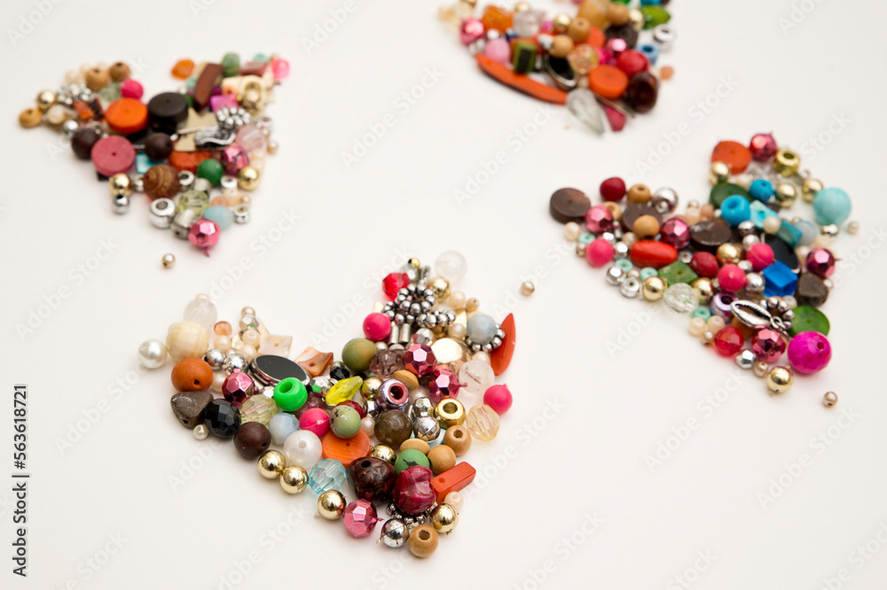 Frame in the shape of hearts. Background of multicolored decorative craft beads. Valentine's Day. Symbol of love.
Frame in the shape of hearts. Background of multicolored decorative craft beads. Valentine's Day. Symbol of love.