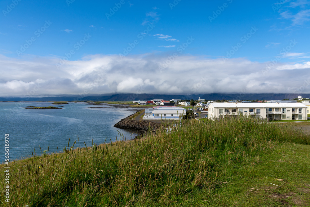 Höfn, Iceland - July 22, 2022: View of Höfn with mountains and clouds in the background