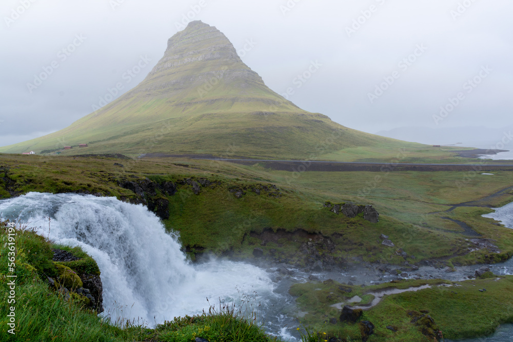 Kirkjufell in Iceland the fog with waterfall in front