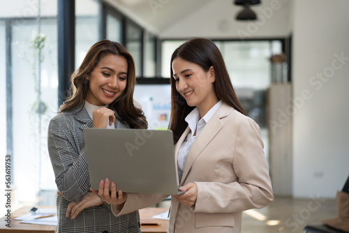 Two casual asian business women at work.