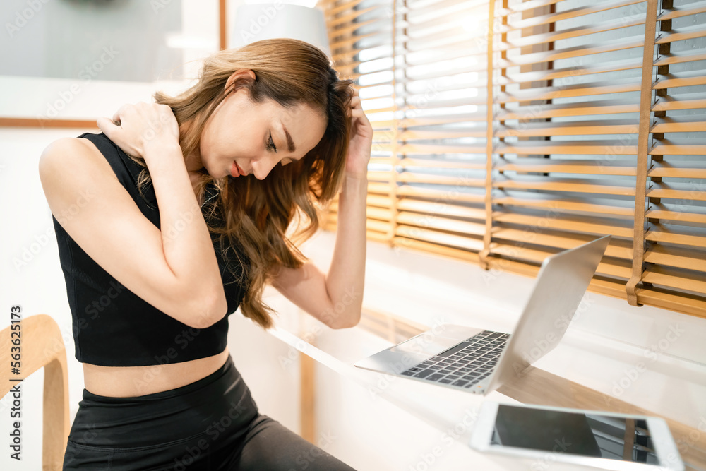 fatigued beautiful woman rubbing neck working using laptop. gorgeous ...