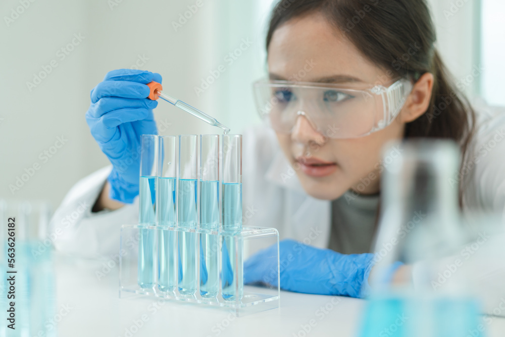 Scientist doing chemical test in research lab to study vaccine Scientist doing chemical test in research lab to study vaccine