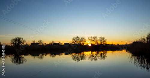 sunset and the smooth surface of the river © cooperr
