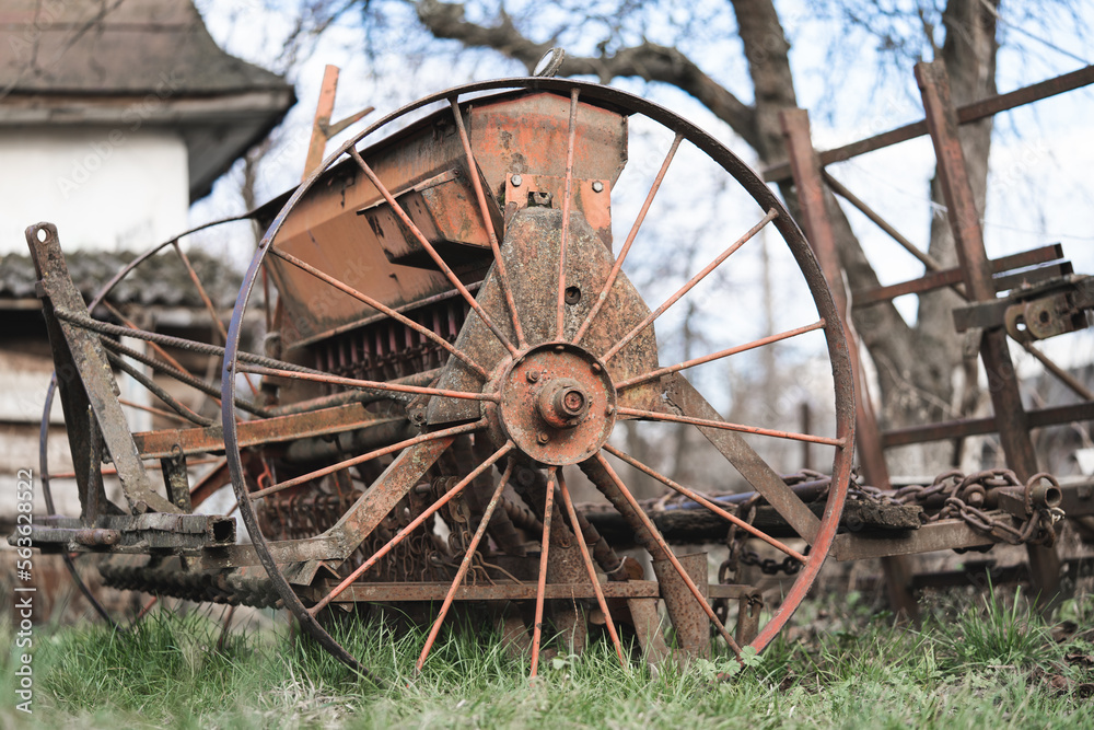 old rusty metal wheel with spokes for work in agriculture