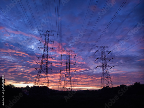 High voltage power transmission towers Have a complex steel structure In the evening. high-voltage power lines at sunset,high voltage electric transmission tower