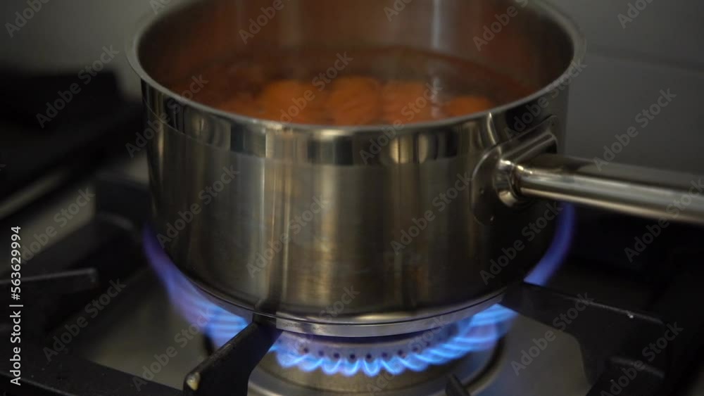 close up slow motion carrots are cooked in a pan with boiling water on the fire close up slow motion carrots are cooked in a pan with boiling water on the fire