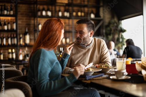 Valentines day couple sitting in favourite caffe  exchanging gifts in hart shape  couple cudling and hugging