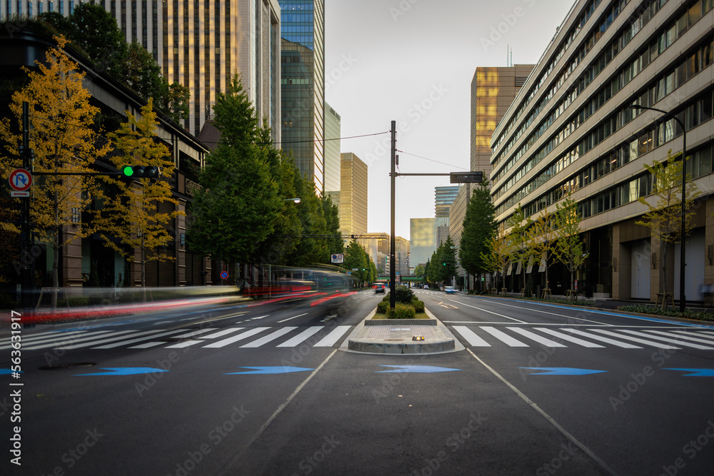 Traffic blurs through downtown intersection with early morning light Traffic blurs through downtown intersection with early morning light