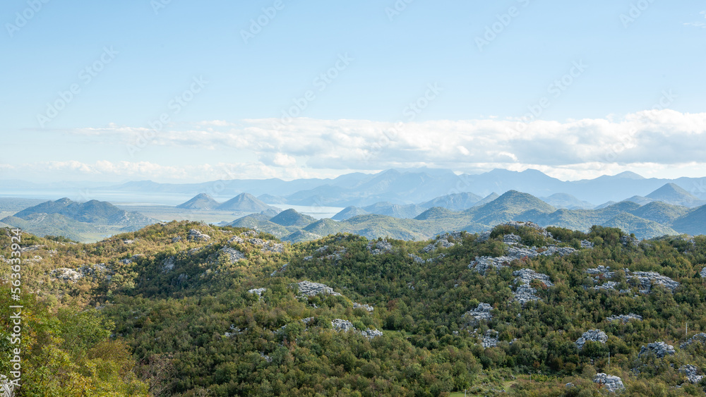 Panoramic view of mountain landscape with blue sky and white clouds. Green mountains for publication, poster, calendar, post, screensaver, wallpaper, postcard, cover, website. High quality photo