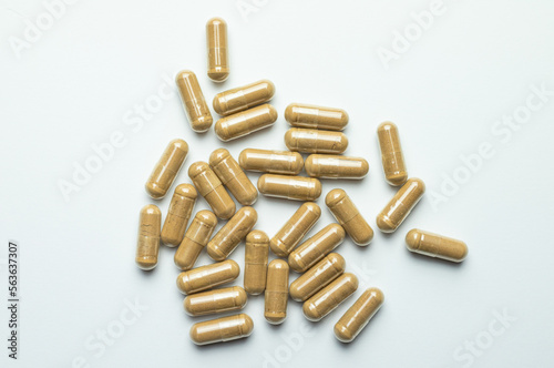 Ashwagandha capsules on a white background, tablets supporting immunity, supplementation of the body with essential ingredients