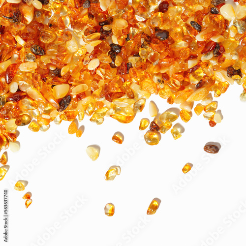 Natural gemstone amber texture background, small stones yellow orange color isolated on white. Natural mineral material for jewelry. Top view Aesthetic Amber textured, pieces ancient resin