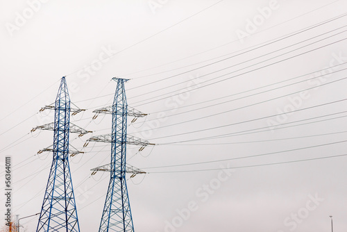 Blue high Pylon high-voltage power lines, high voltage electric transmission tower for producing electricity at high voltage electricity poles at the sunset.