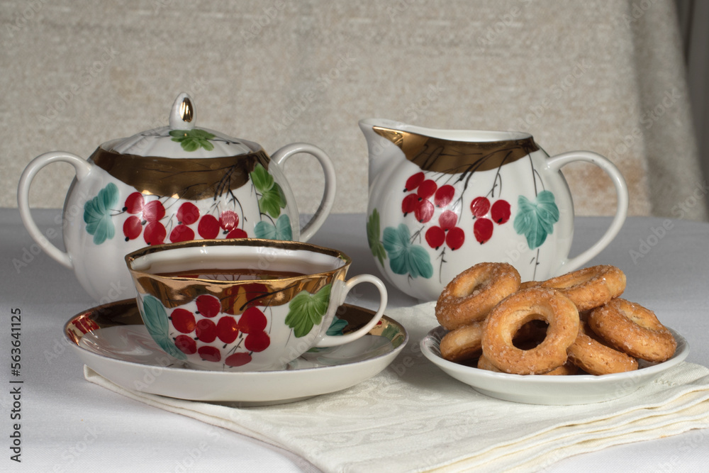 tea set with cookies on a white tablecloth