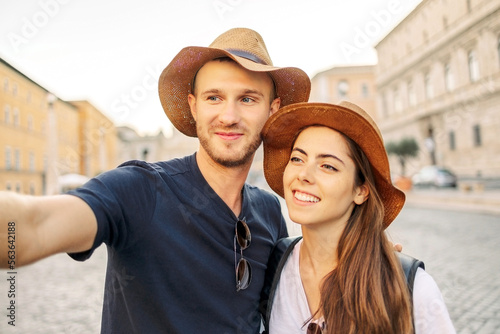 Happy Young couple taking selfie portrait with smartphone mobile outdoor. Tourism, friendship, youth and weekend activities concept. Close up portrait. Tourism, selfie photos, bloggers © Olga