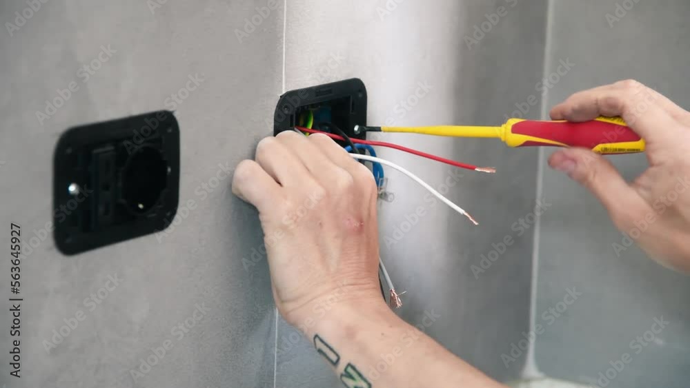 Electrician working on switches and sockets of a residential electrical system