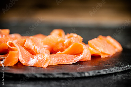 Slices of salted salmon on the table. 