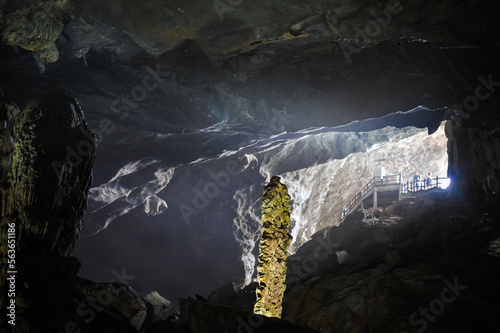 large foggy illuminated underground cave in limestone rock in vietnam