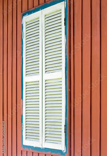 Old white window closed in red wall © Casa.da.Photo