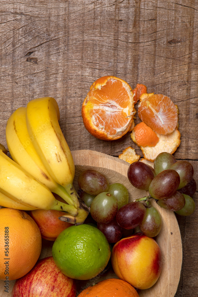 Trough with assorted fruits, on rustic table. Space for text Trough with assorted fruits, on rustic table. Space for text