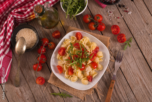 Orecchiette pasta with arugula and tomato.