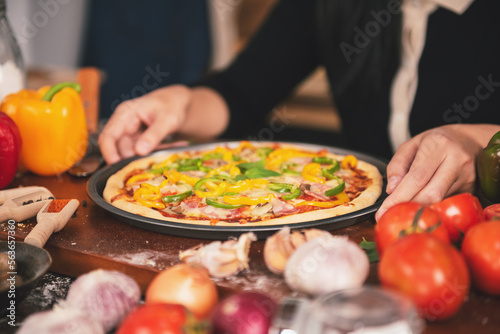 Close up Chef preparing pizza ingredients and spices preparatio on wood table, Homemade pizza cooking in the kitchen at home.