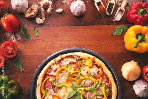 Top view of pizza ingredients and spices preparation on wood table, Homemade pizza cooking in the kitchen at home.