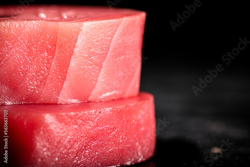 Raw tuna steaks on the table. 