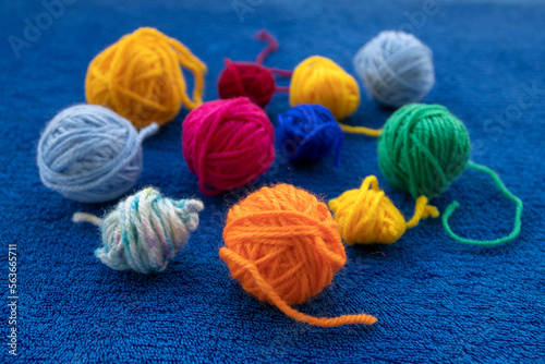 Close-up of colorful yarn balls on blue cloth