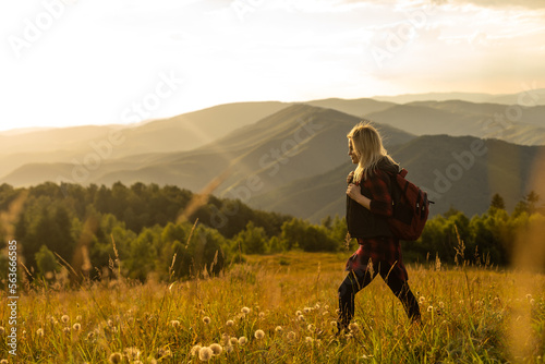 Girl Traveler hiking with backpack at rocky mountains landscape Travel Lifestyle concept adventure summer vacations outdoor.