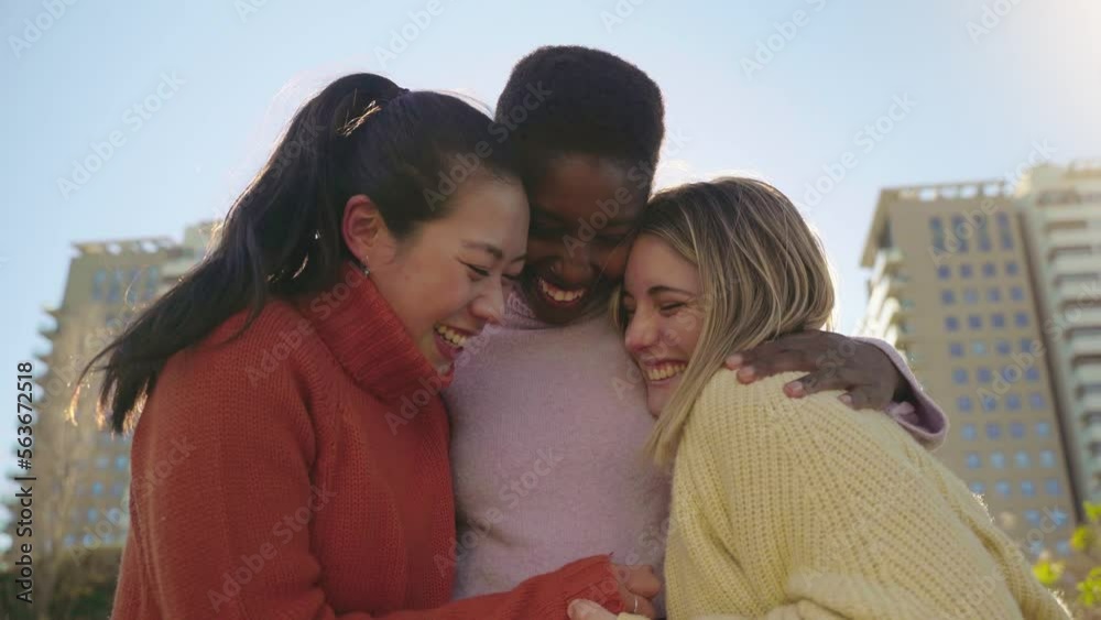 Three female friends affectionately hug each other having fun together laughing happy smiling. Collective lovely embrace concept. High quality 4k footage Three female friends affectionately hug each other having fun together laughing happy smiling. Collective lovely embrace concept. High quality 4k footage