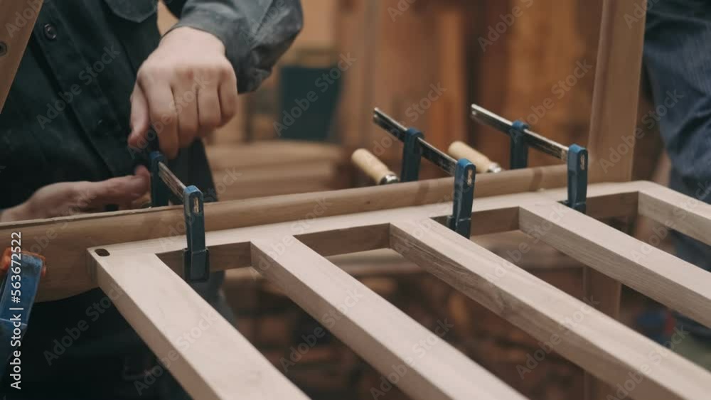 Carpenter in the workshop working on the creation of handmade wooden furniture. Profession, joinery, Craftsmanship, Handicrafts, woodwork and people concept