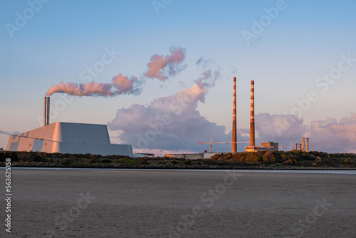 Poolbeg chimneys at dusk, power plants emitting fumes, electricity production, Dublin, Ireland