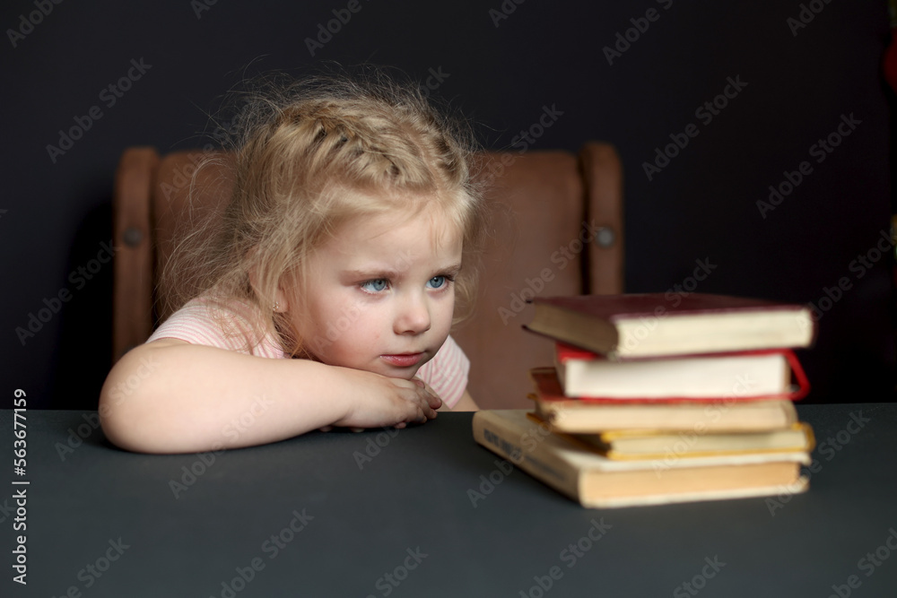 While preparing for school, the child studies at home. Distance learning, homework While preparing for school, the child studies at home. Distance learning, homework