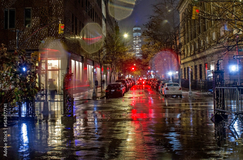 Street lights and brake lights on a rainy night in New York City.