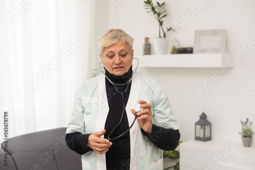 Caucasian senior female doctor confidently with stethoscope