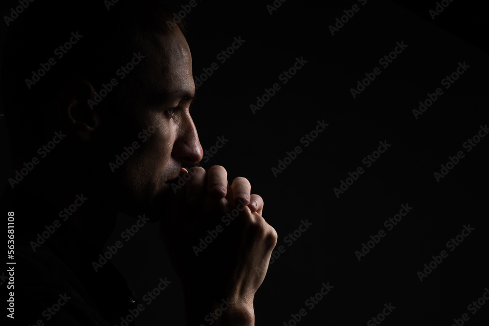 Portrait of a handsome man praying over gray background Portrait of a handsome man praying over gray background