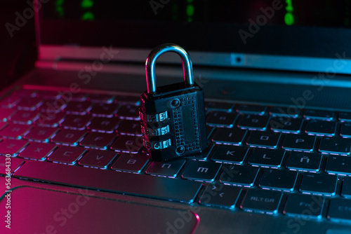 Photo Lock on laptop as computer protection and cyber safety concept on neon background