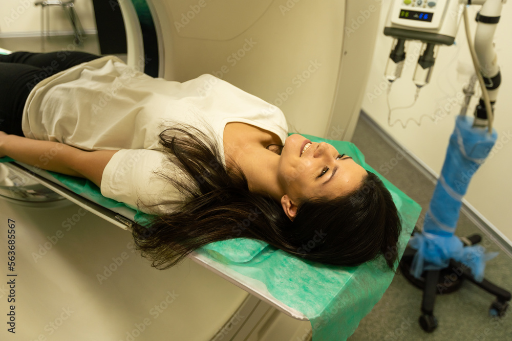 Computed tomography of the pelvis and hard tissues for women. CT scan to cure tissue diseases. Professional diagnosis of the organs of a young girl. Computed tomography of the pelvis and hard tissues for women. CT scan to cure tissue diseases. Professional diagnosis of the organs of a young girl.