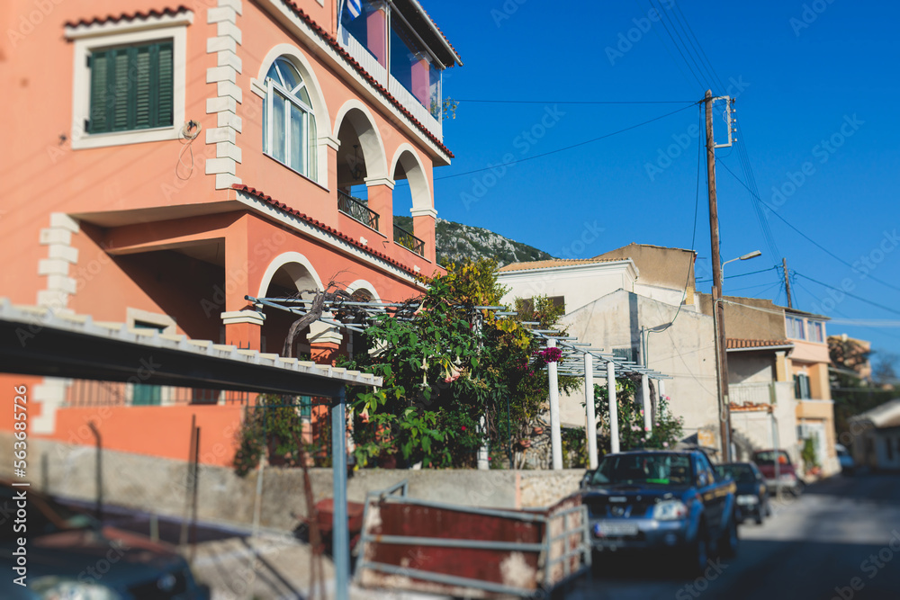 Beautiful view of Lakones streets and houses, traditional greek village near Paleokastritsa, Corfu island, Kerkyra, Ionian sea islands, Greece, in summer sunny day with blue sky and mountains