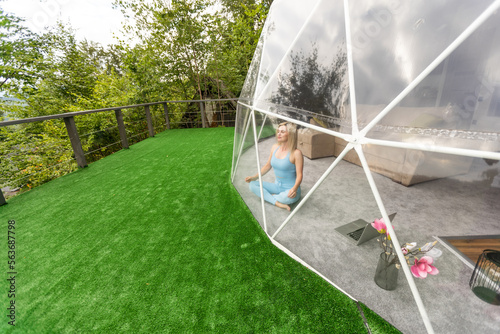 Sporty woman doing exercise in a geo dome glamping tent